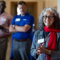 Diana Lawson, dean of Seidman College of Business, = standing and addressing audience